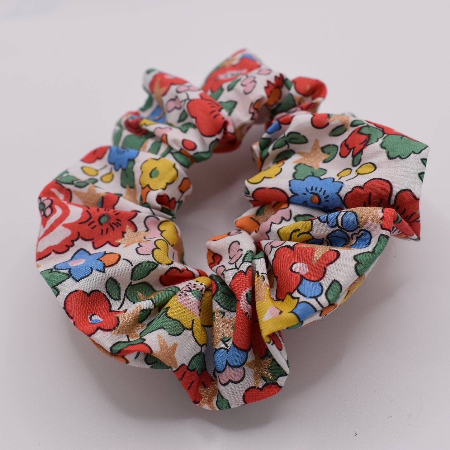A girls hair scrunchie made in Liberty fabric and Betsy Star White pattern. Made for girls by The Blossom Tree House. Front on view