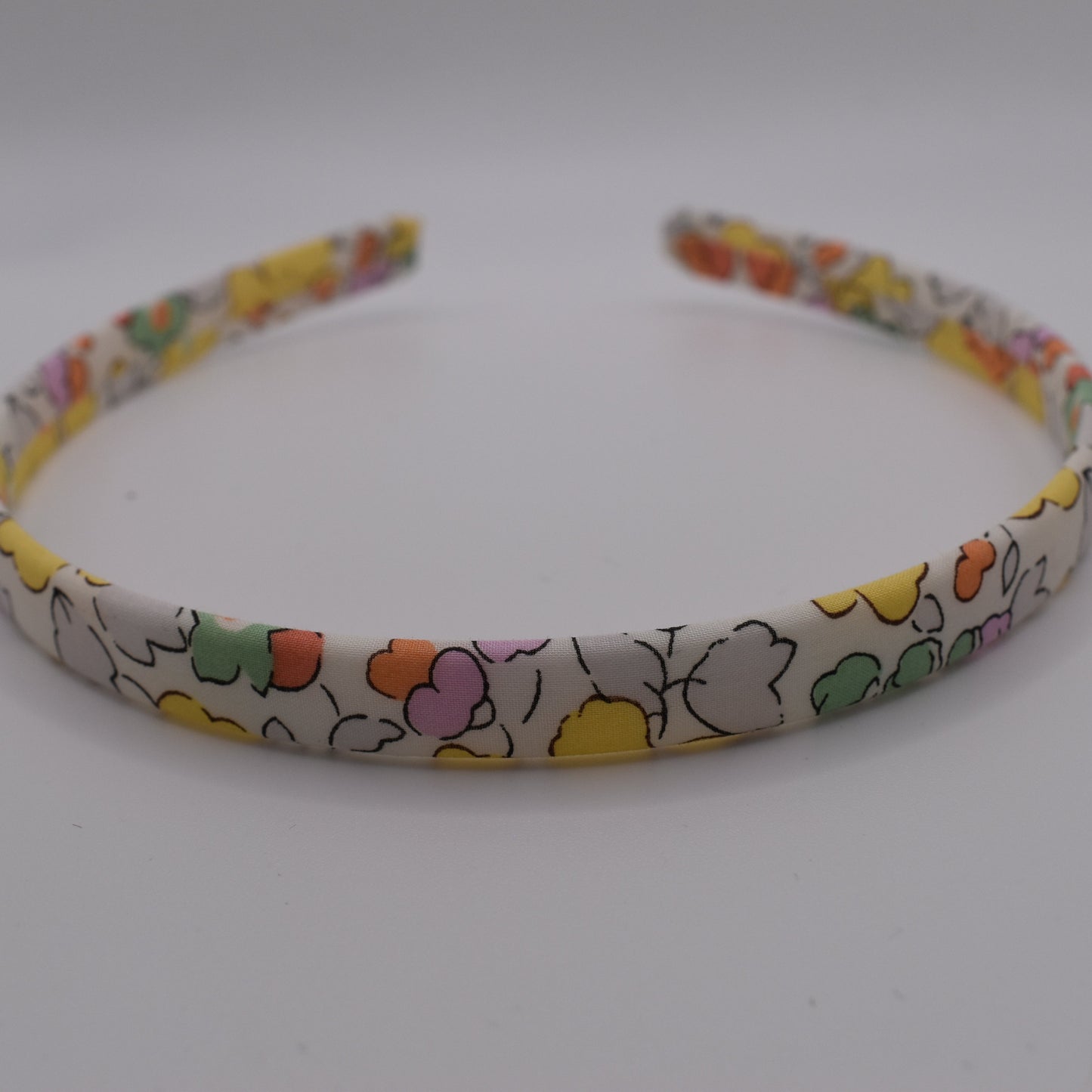 Liberty Headband for Girls in Betsy Yellow pattern. Handmade by The Blossom Tree House. Front on view