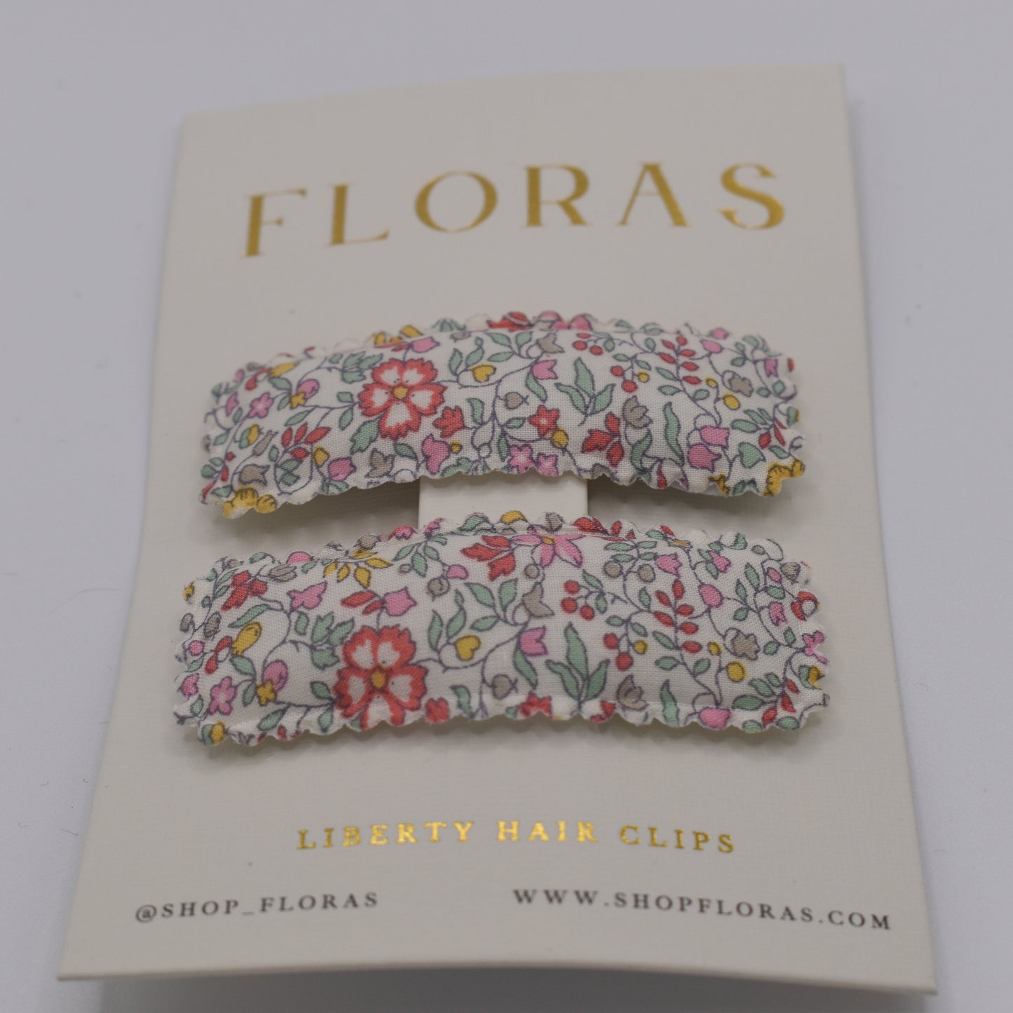 A pair of liberty print barrette clips in Katie and Millie B pattern. Front view. Made by Floras