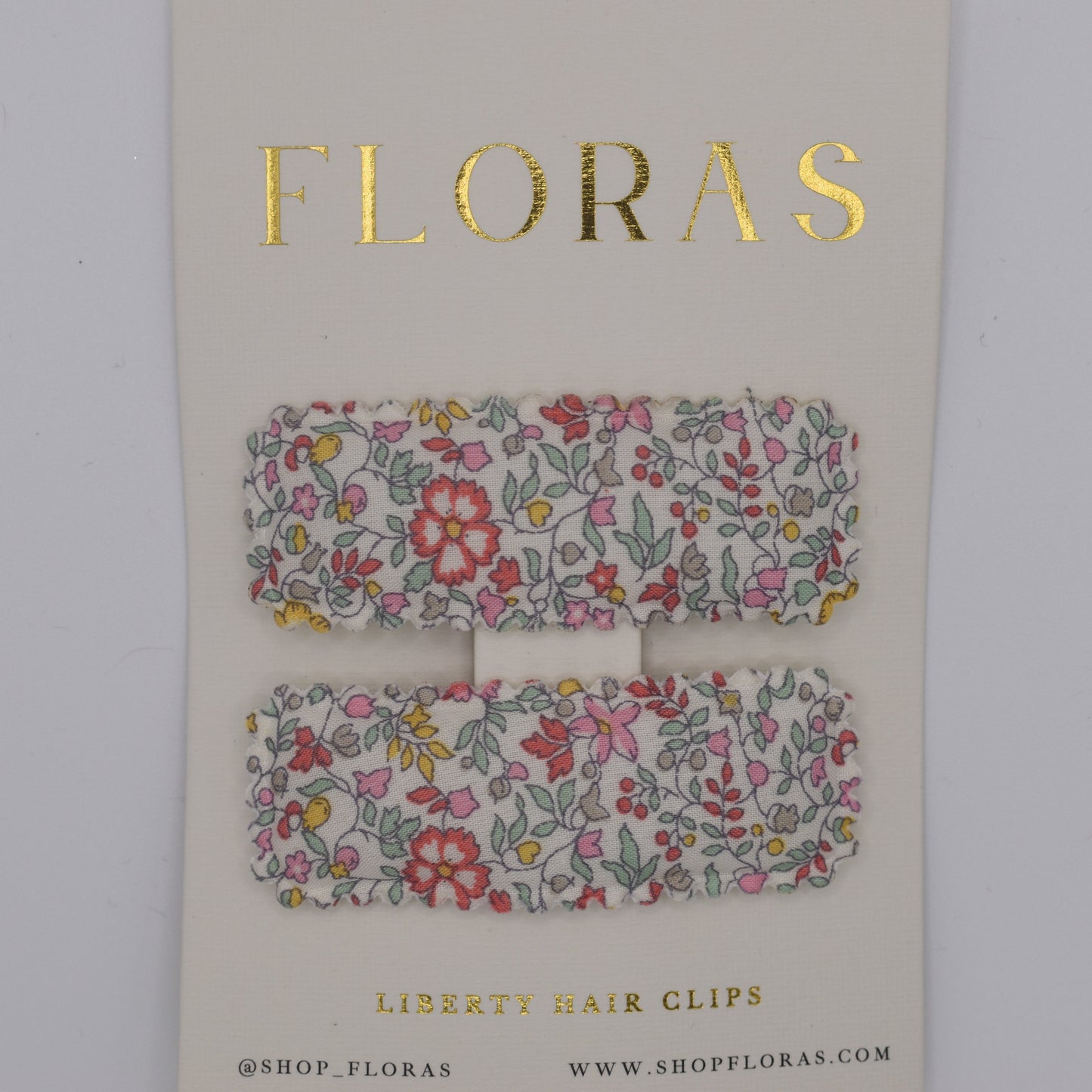 A pair of liberty print barrette clips in Katie and Millie B pattern. Top view. Made by Floras