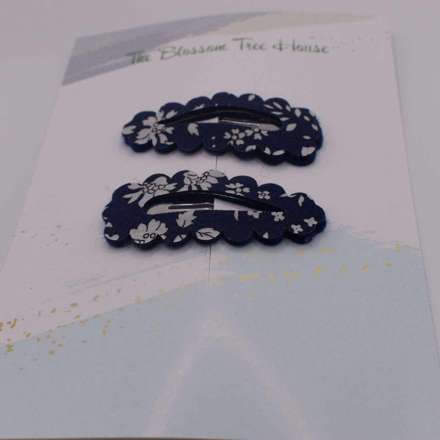 A barrette hair clip with a Liberty print design in Navy Capel. Front-on view. Made by The Blossom Tree House