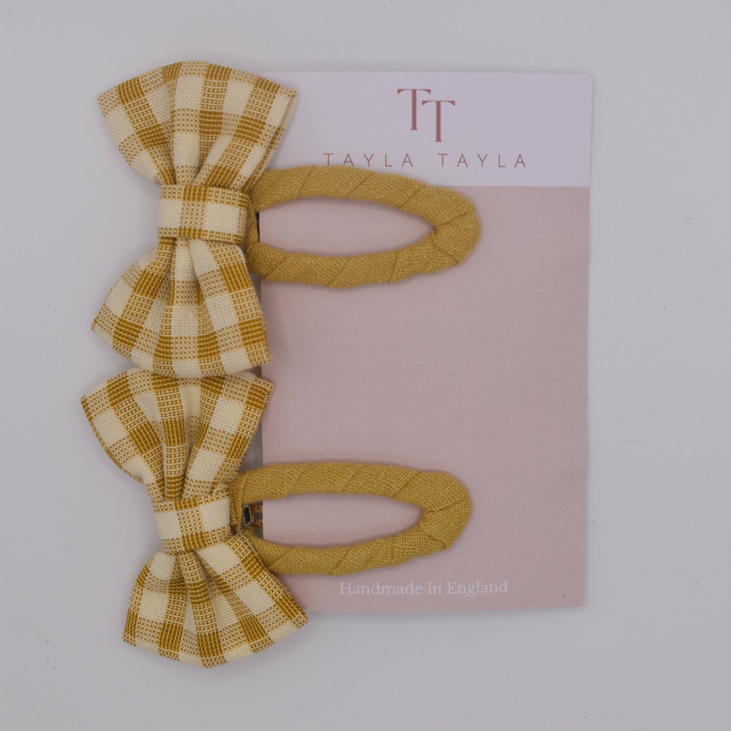 A set of yellow gingham bow hair clips for girls. Fabric material. Top view. Made by Tayla Tayla