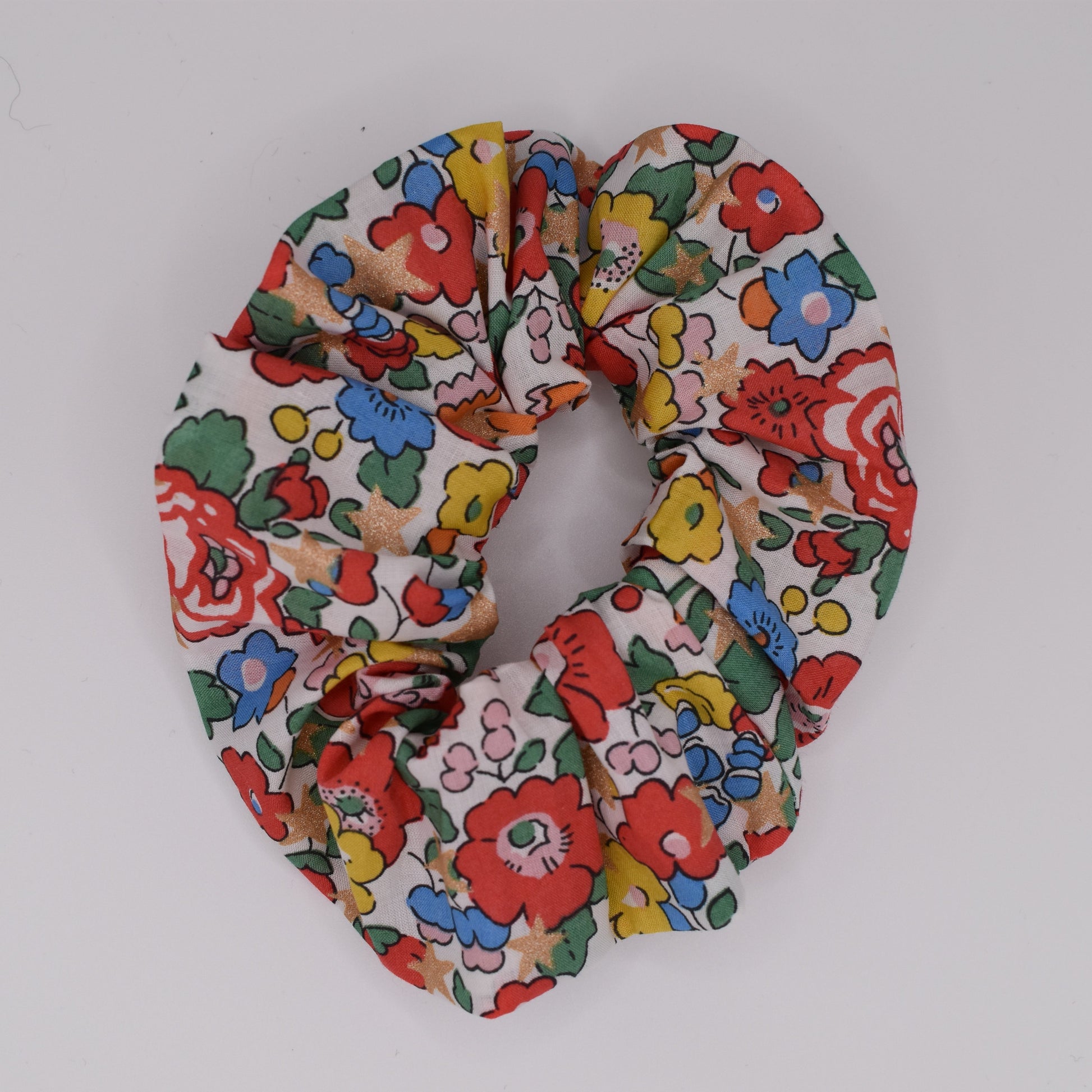 A girls hair scrunchie made in Liberty fabric and Betsy Star White pattern. Made for girls by The Blossom Tree House. Top down view