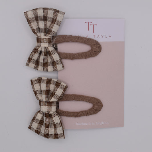 A set of chocolate gingham bow hair clips for girls. Fabric material. Top view. Made by Tayla Tayla