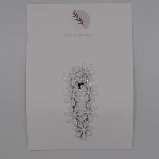 A daisy chain hair clip for girls. White fabric. Top view. Made by Studio Frommie