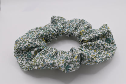 This is a Liberty of London hair scrunchie made by The Blossom Tree House in Katie and Millie Green cotton. Perfect for girls. Front view