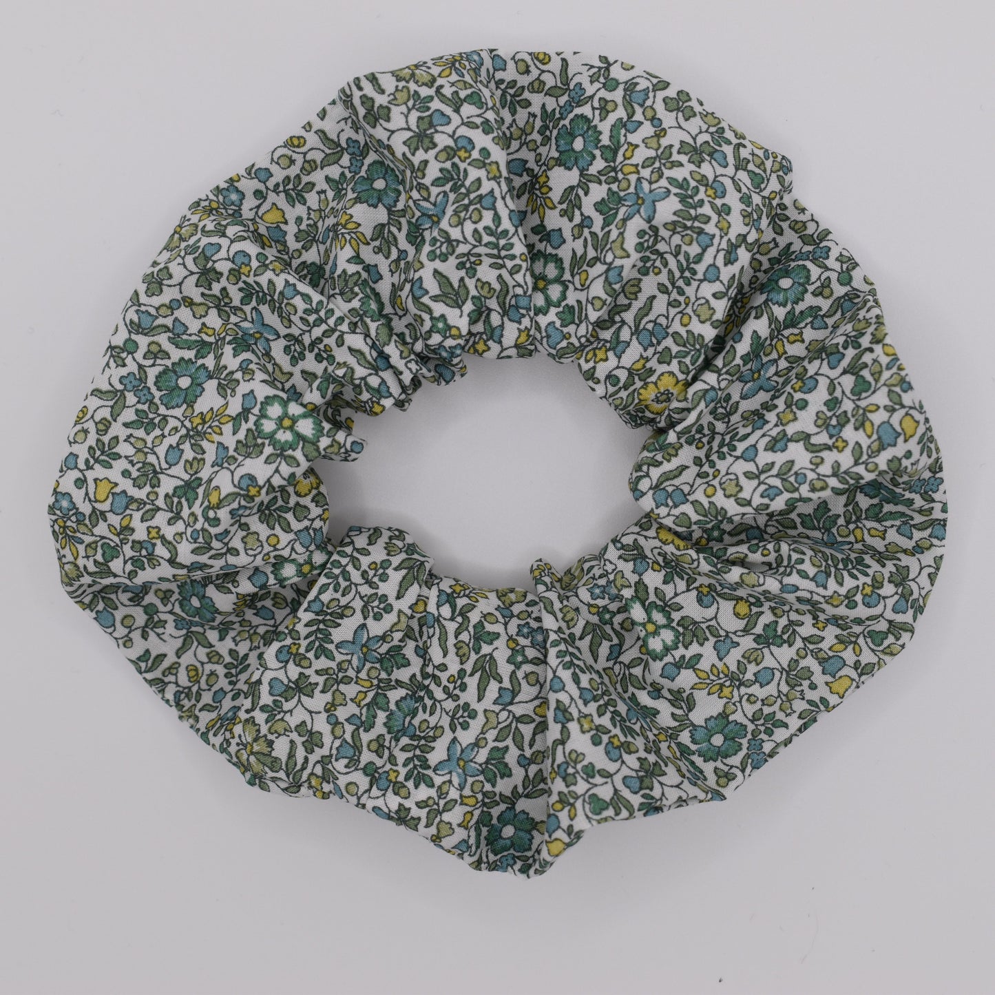 This is a Liberty of London hair scrunchie made by The Blossom Tree House in Katie and Millie Green cotton. Perfect for girls. Top view