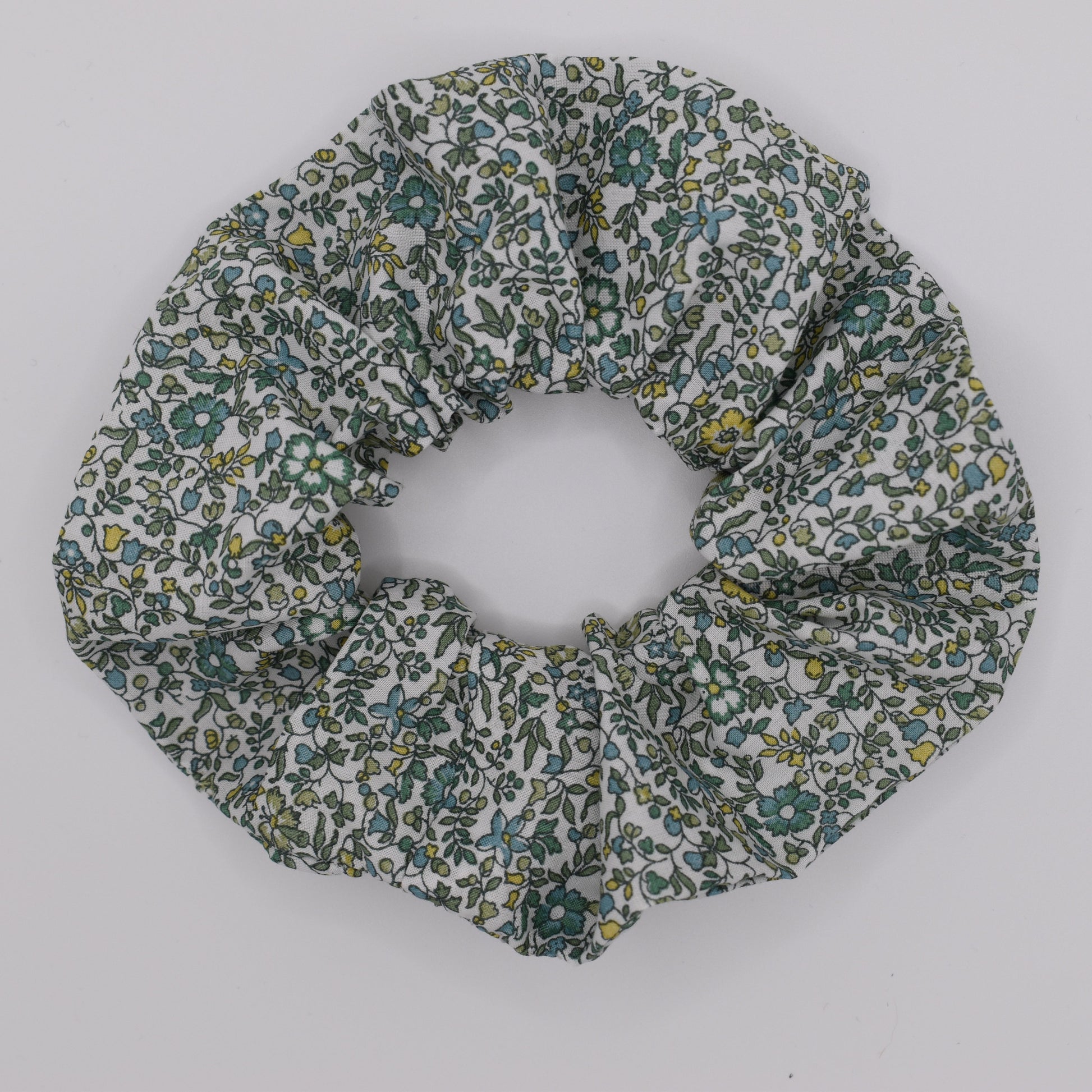 This is a Liberty of London hair scrunchie made by The Blossom Tree House in Katie and Millie Green cotton. Perfect for girls. Top view