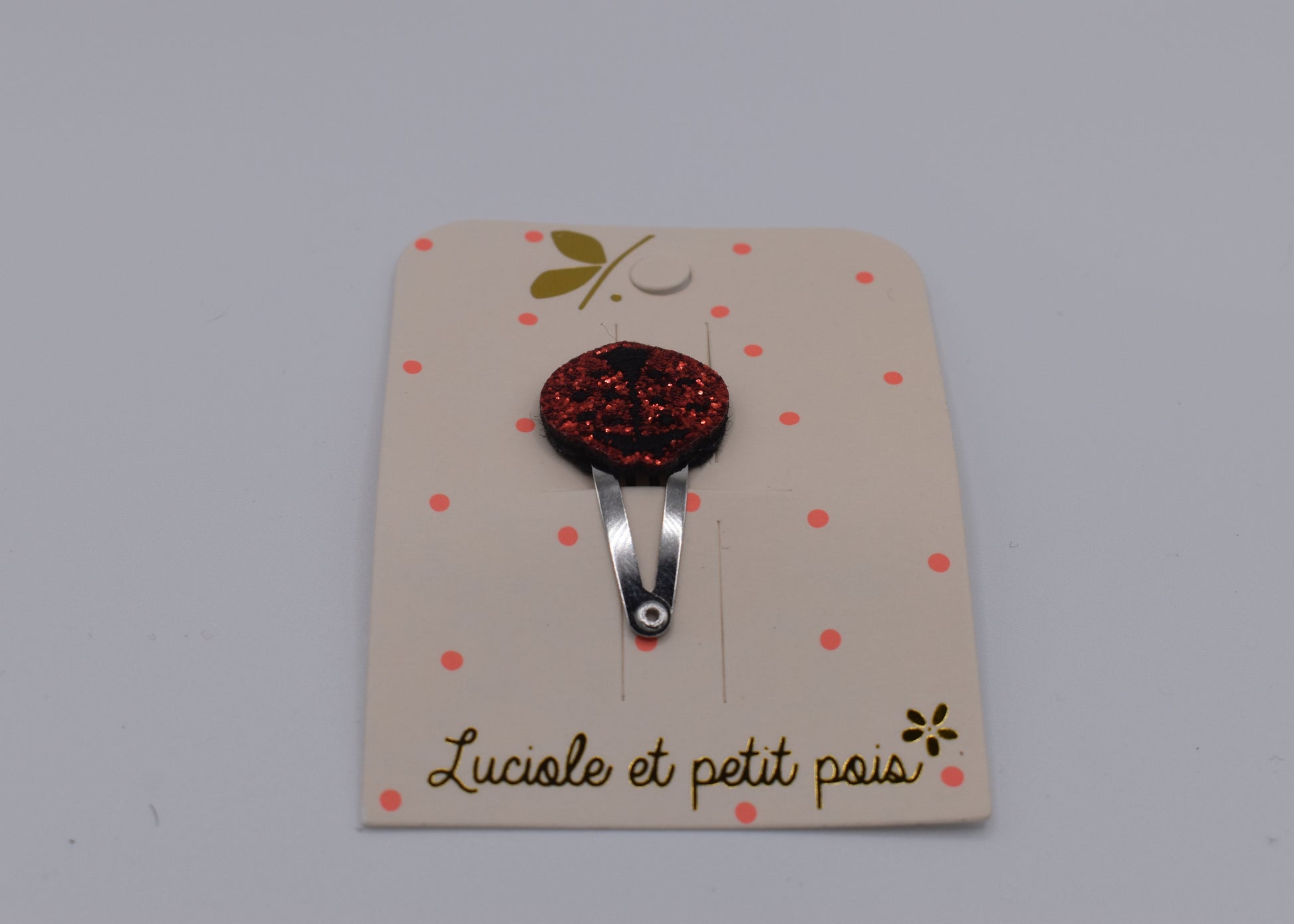 A glitter ladybird hair clip for girls. Red colour. Front view. Made by Luciole et Petit Pois