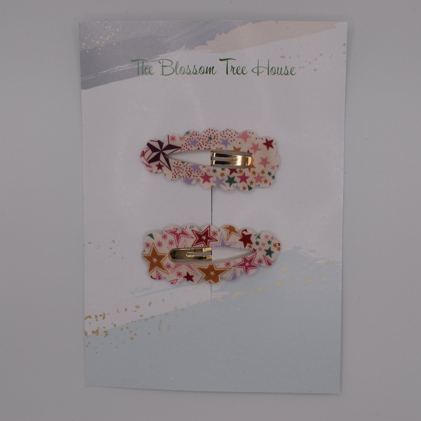 A barrette hair clip with a Liberty print design in Adelajda Red. Top-down view. Made by The Blossom Tree House