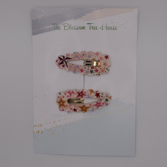 A barrette hair clip with a Liberty print design in Adelajda Red. Top-down view. Made by The Blossom Tree House