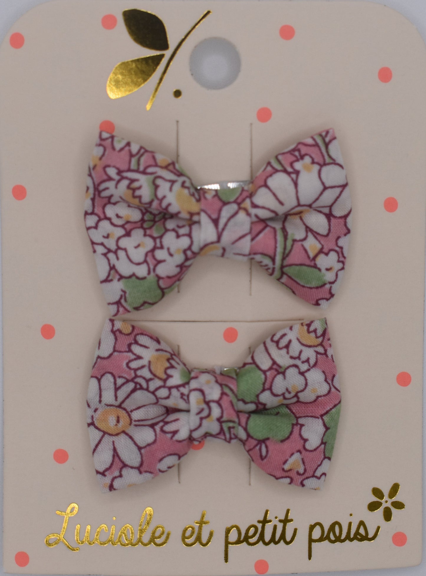 A pair of liberty bow hair clips in Alice Peach pattern. Floral design. Top view. Made by Luciole et Petit Pois