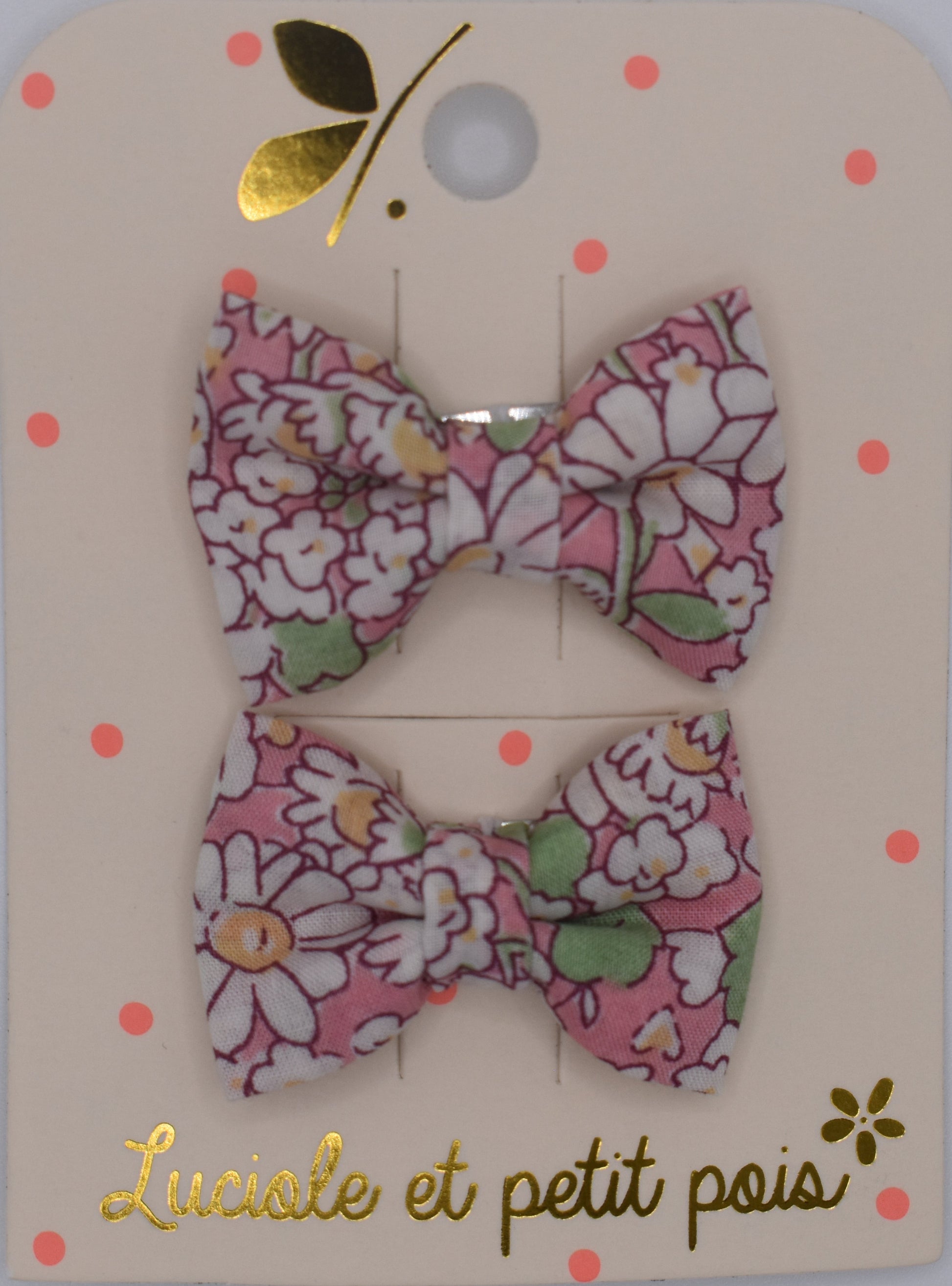 A pair of liberty bow hair clips in Alice Peach pattern. Floral design. Top view. Made by Luciole et Petit Pois