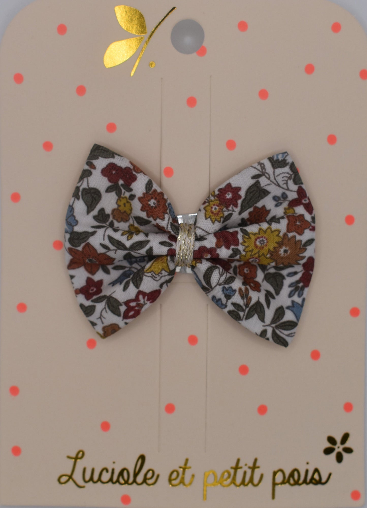 A liberty bow hair clip in Ava Autumn pattern. Floral pattern. Top view. Made by Luciole et Petit Pois