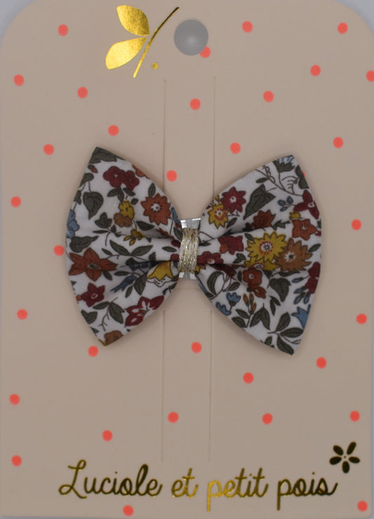 A liberty bow hair clip in Ava Autumn pattern. Floral pattern. Top view. Made by Luciole et Petit Pois