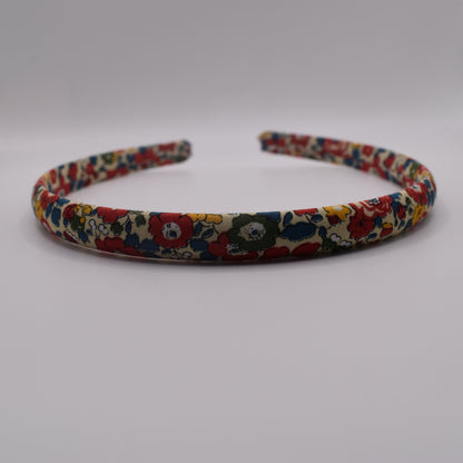A girl's liberty print headband in Betsy Ann B Red. Front-on view. Made by The Blossom Tree House