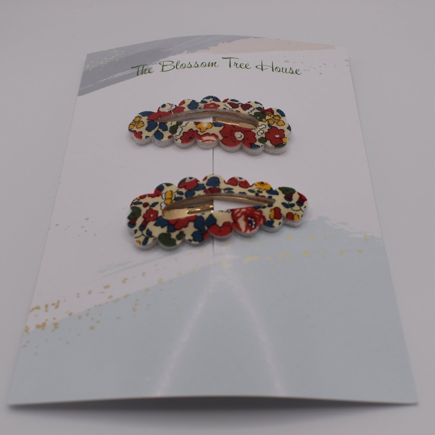 A barrette hair clip with a Liberty print design in Betsy Ann B Red. Front-on view. Made by The Blossom Tree House