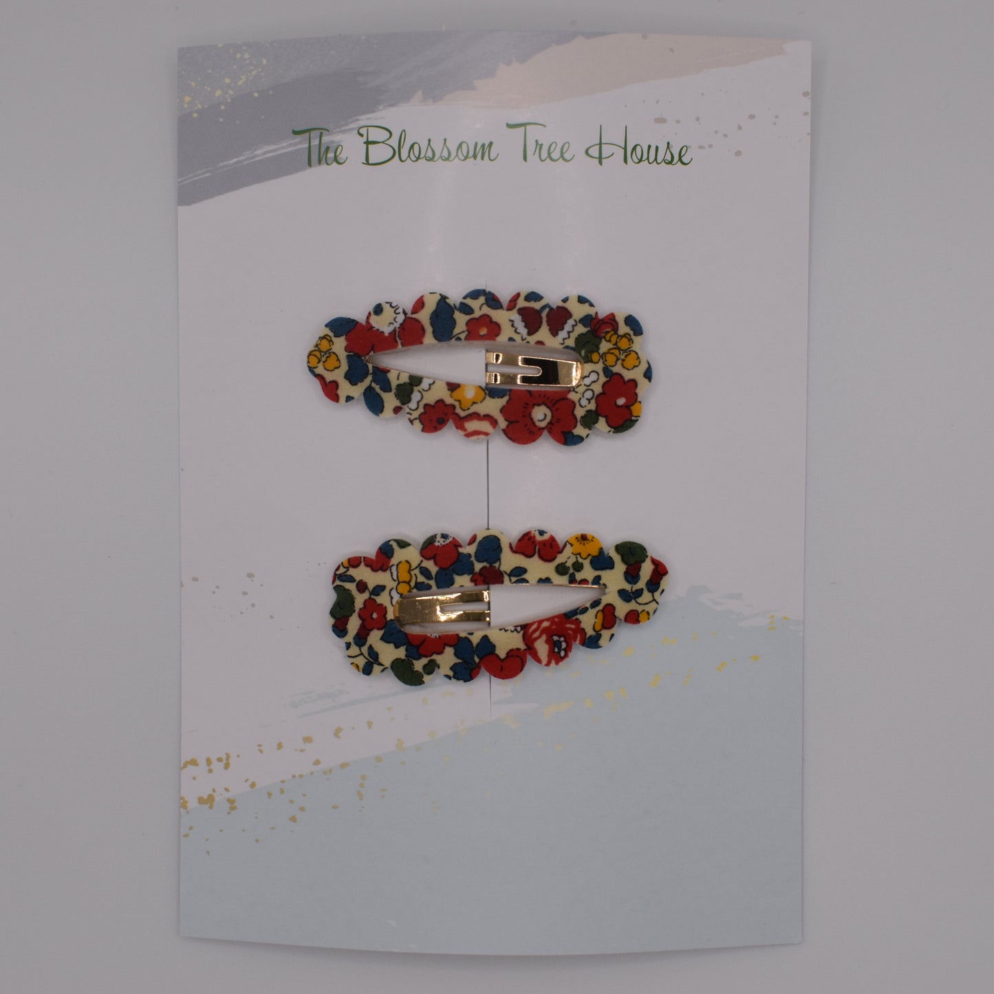 A barrette hair clip with a Liberty print design in Betsy Ann B Red. Top-down view. Made by The Blossom Tree House