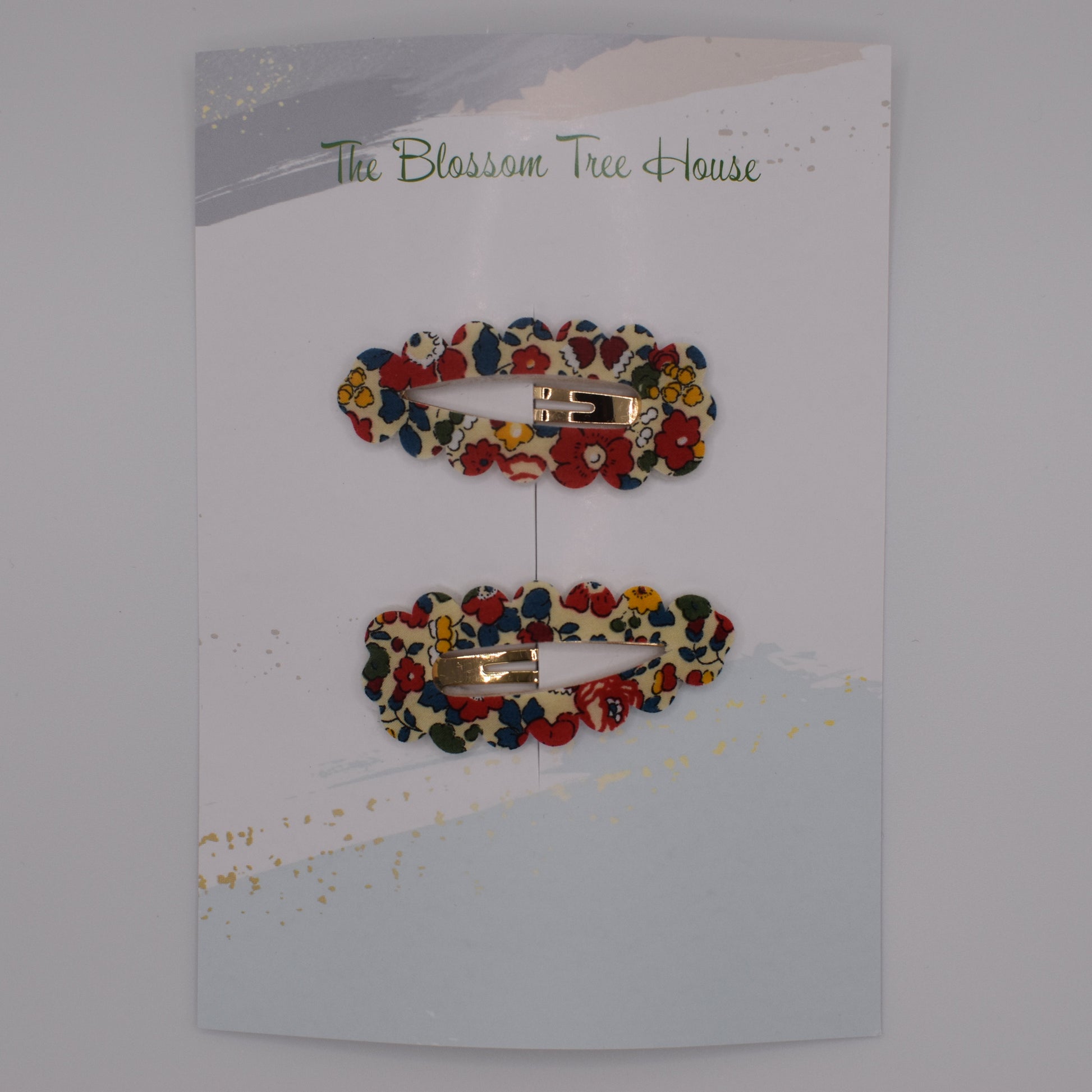 A barrette hair clip with a Liberty print design in Betsy Ann B Red. Top-down view. Made by The Blossom Tree House