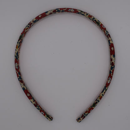 A girl's liberty print headband in Betsy Ann B Red. Top-down view. Made by The Blossom Tree House