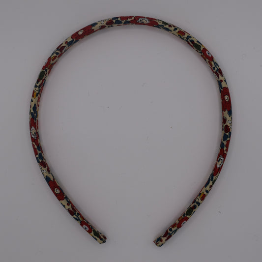 A girl's liberty print headband in Betsy Ann B Red. Top-down view. Made by The Blossom Tree House