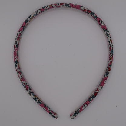 A girl's liberty print headband in Betsy Ann E. Top-down view. Made by The Blossom Tree House