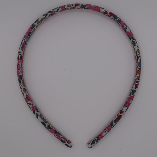 A girl's liberty print headband in Betsy Ann E. Top-down view. Made by The Blossom Tree House