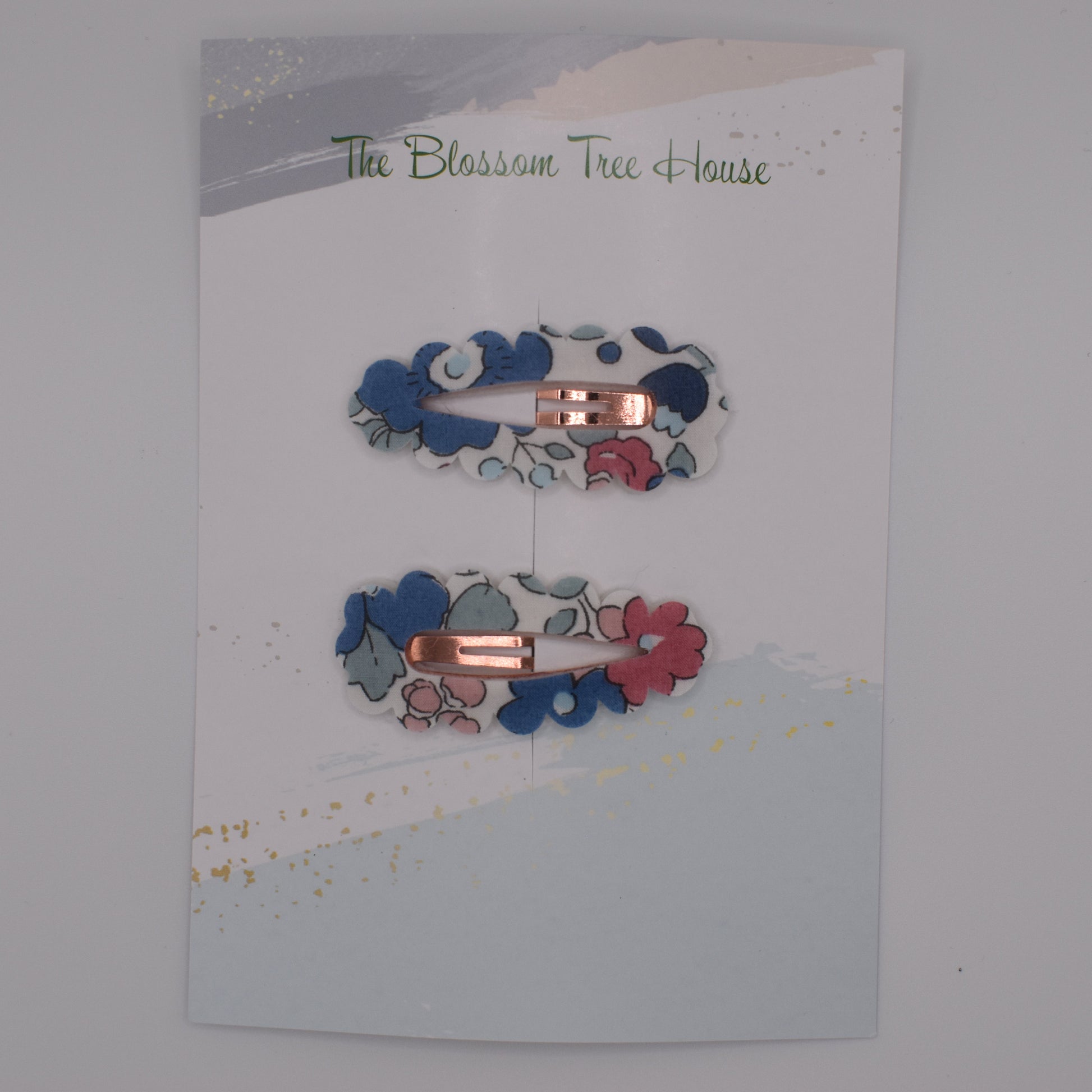 A barrette hair clip with a Liberty print design in Betsy Blue. Top-down view. Made by The Blossom Tree House