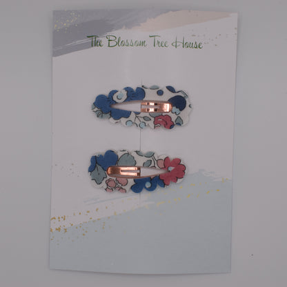 A barrette hair clip with a Liberty print design in Betsy Blue. Top-down view. Made by The Blossom Tree House