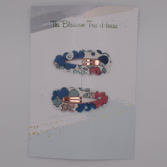 A barrette hair clip with a Liberty print design in Betsy Blue. Top-down view. Made by The Blossom Tree House