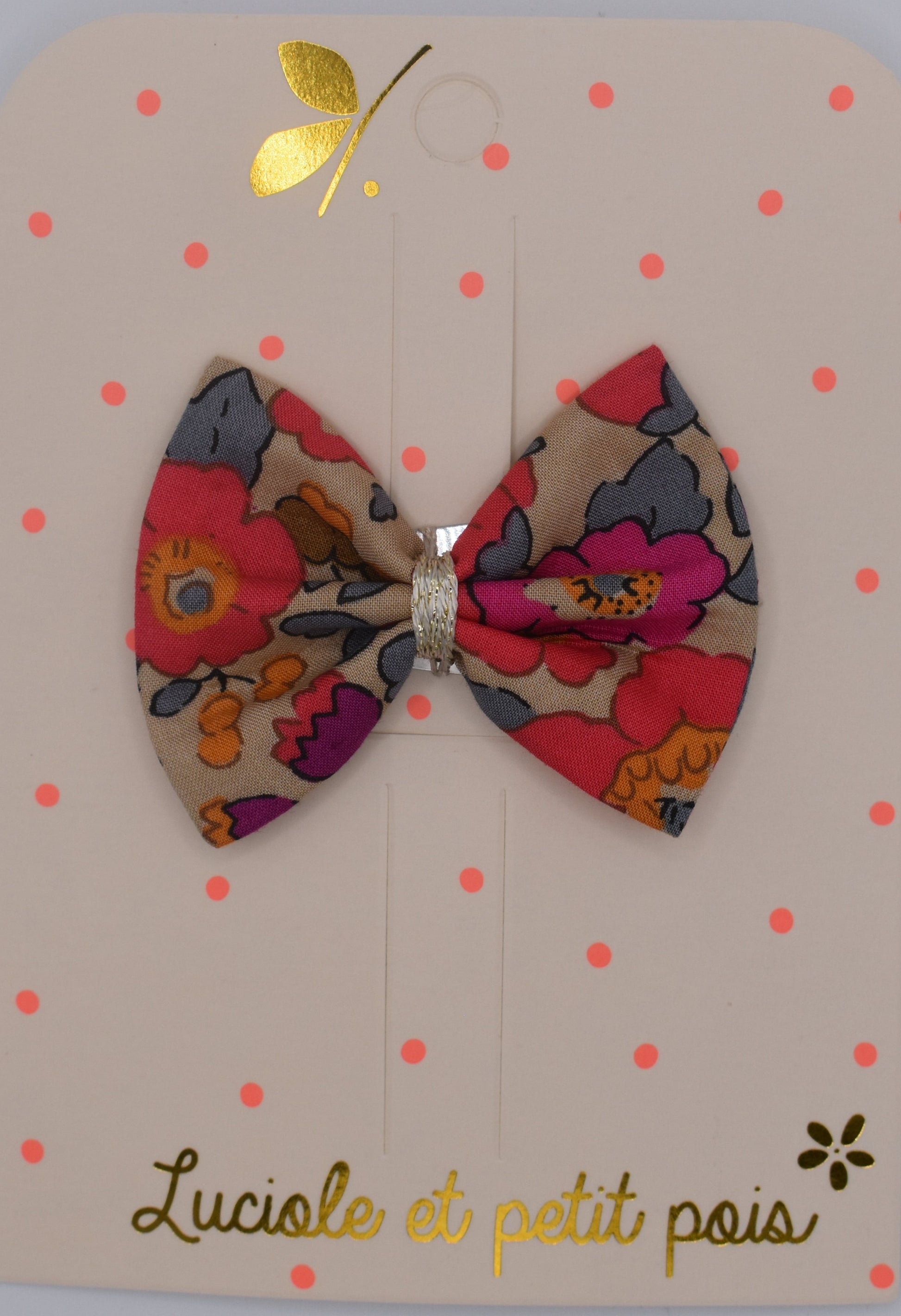 A liberty bow hair clip in Betsy Fluo Tea pattern. Top view. Made by Luciole et Petit Pois