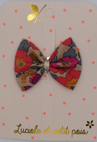 A liberty bow hair clip in Betsy Fluo Tea pattern. Top view. Made by Luciole et Petit Pois