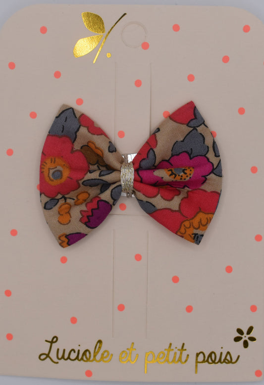 A liberty bow hair clip in Betsy Fluo Tea pattern. Top view. Made by Luciole et Petit Pois