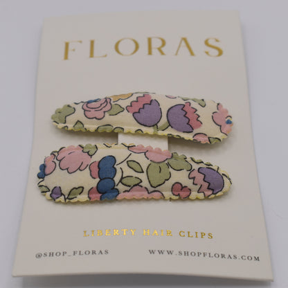 A pair of liberty print barrette clips in Betsy Sucre Dore pattern. Front view. Made by Floras