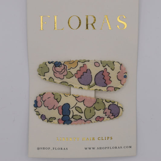 A pair of liberty print barrette clips in Betsy Sucre Dore pattern. Top view. Made by Floras
