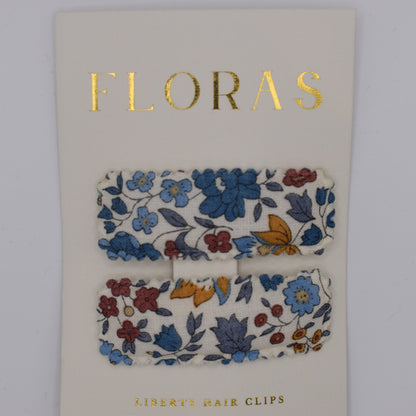 A pair of liberty print barrette clips in D'Anjou Linen Blue pattern. Top view. Made by Floras