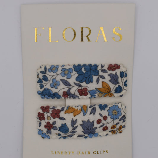 A pair of liberty print barrette clips in D'Anjou Linen Blue pattern. Top view. Made by Floras