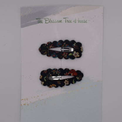 A barrette hair clip with a Liberty print design in Donna Leigh Black. Top-down view. Made by The Blossom Tree House