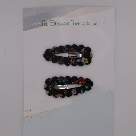 A barrette hair clip with a Liberty print design in Donna Leigh Black. Top-down view. Made by The Blossom Tree House