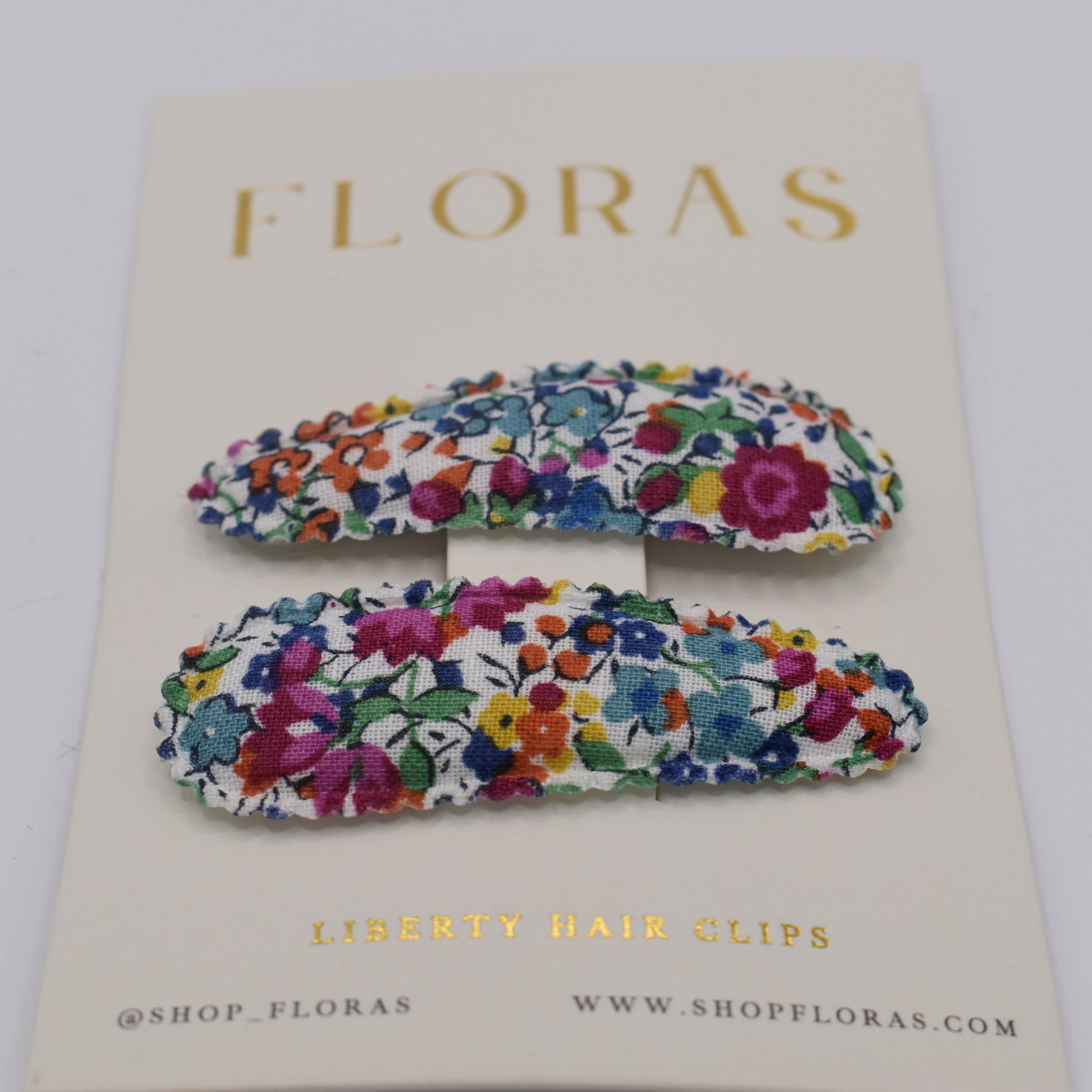 A pair of liberty print barrette clips in Emma and Georgina Linen pattern. Front view. Made by Floras