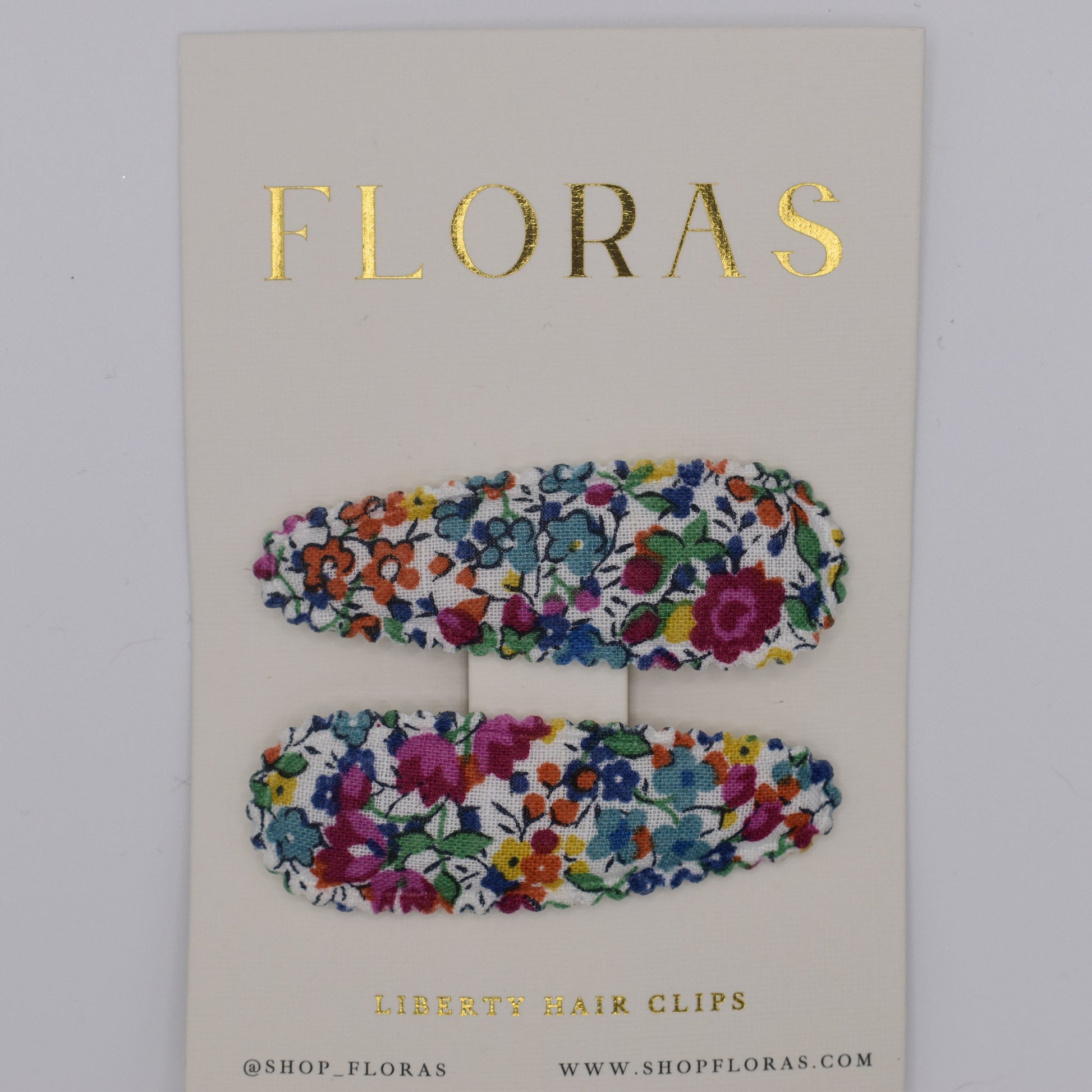 A pair of liberty print barrette clips in Emma and Georgina Linen pattern. Top view. Made by Floras