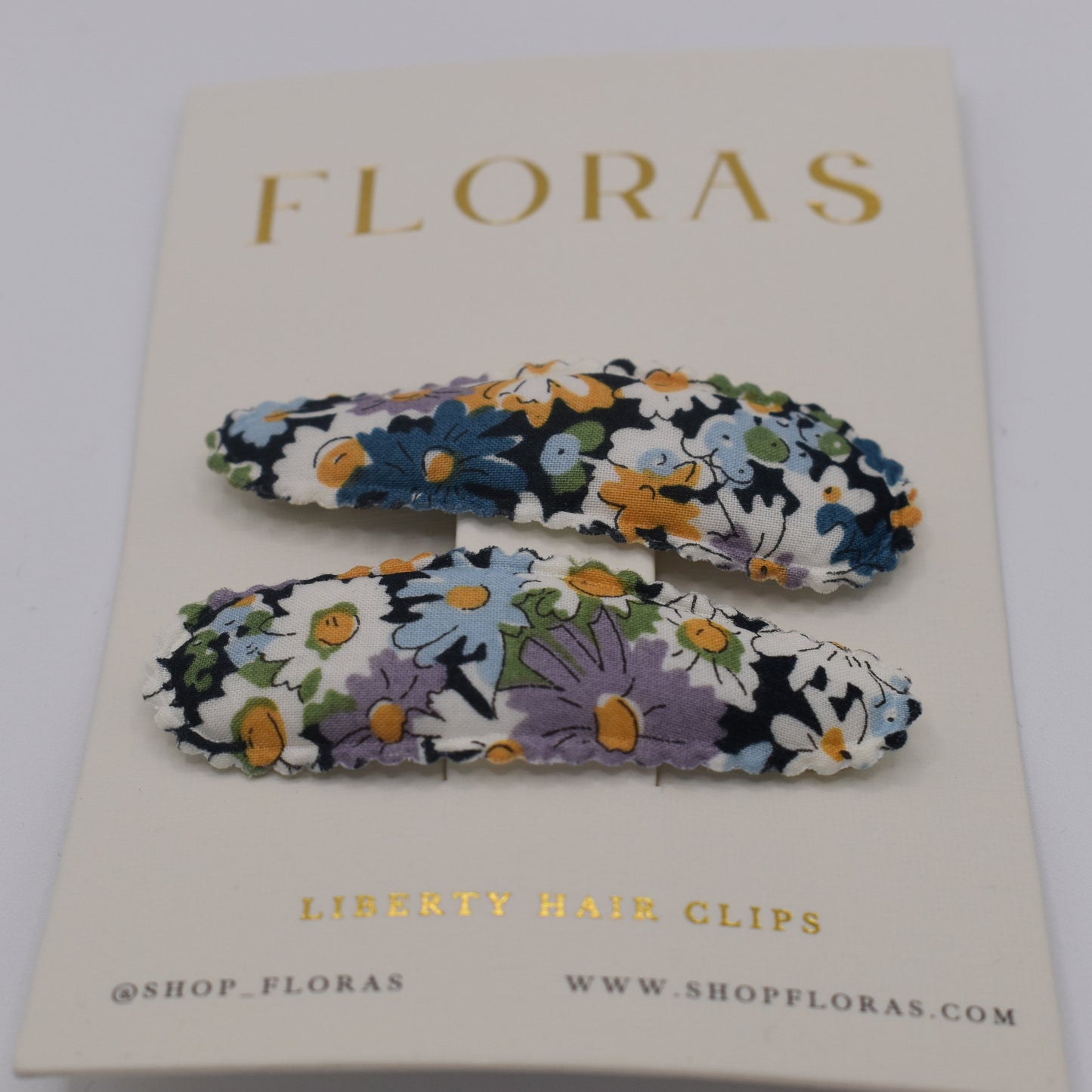 A pair of liberty print barrette clips in Libby B pattern. Front view. Made by Floras