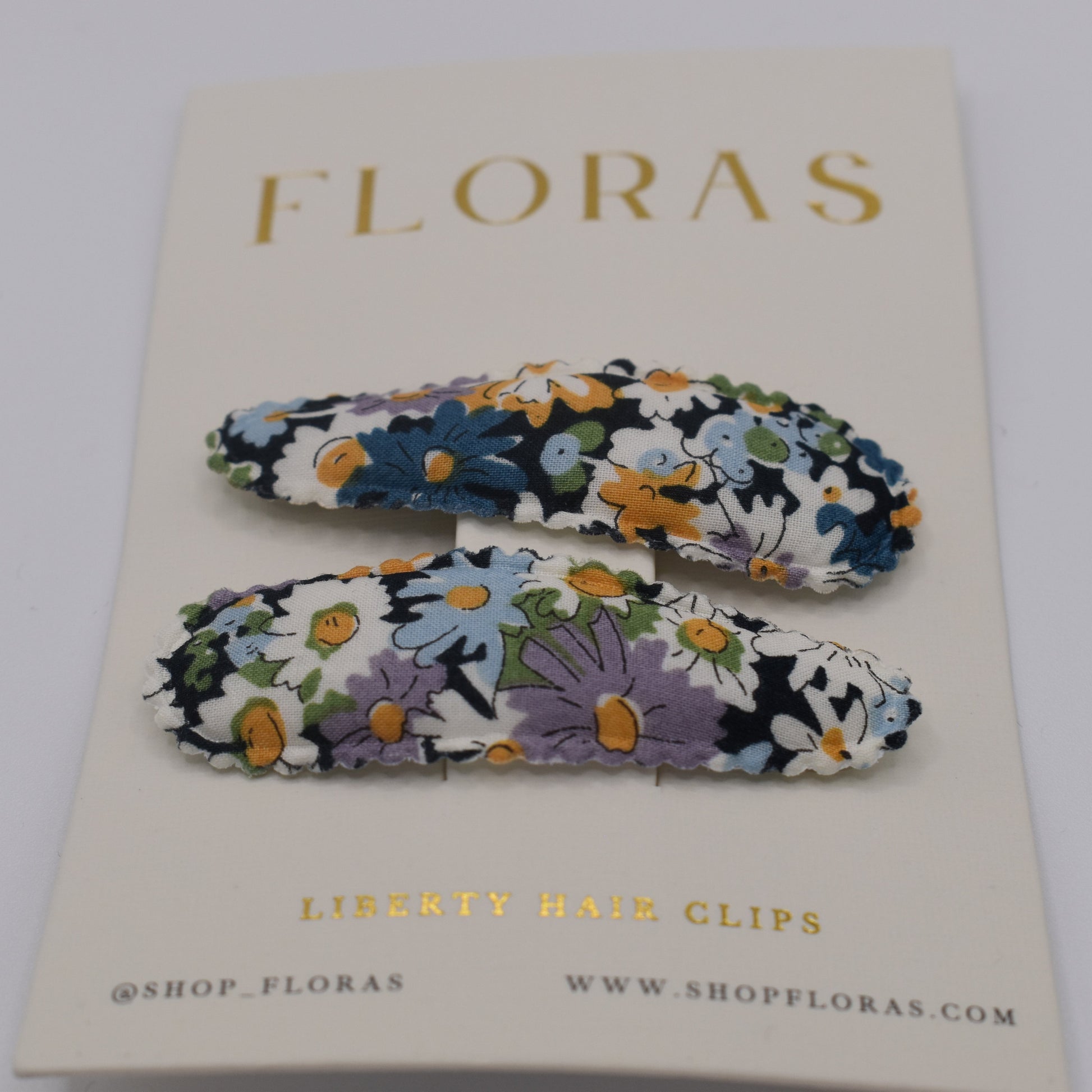 A pair of liberty print barrette clips in Libby B pattern. Front view. Made by Floras
