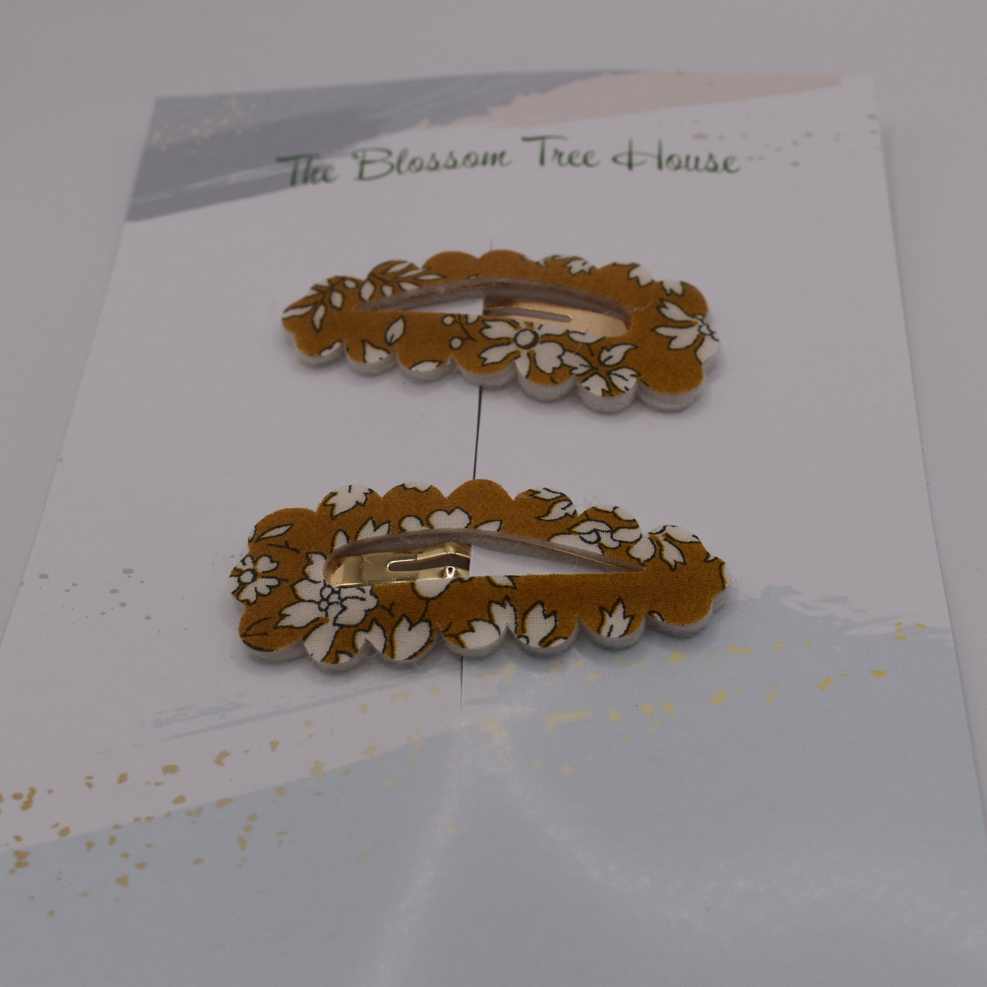 A barrette hair clip with a Liberty print design in Mustard Capel. Front-on view. Made by The Blossom Tree House