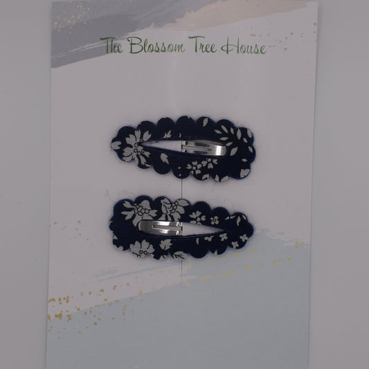 A barrette hair clip with a Liberty print design in Navy Capel. Top-down view. Made by The Blossom Tree House