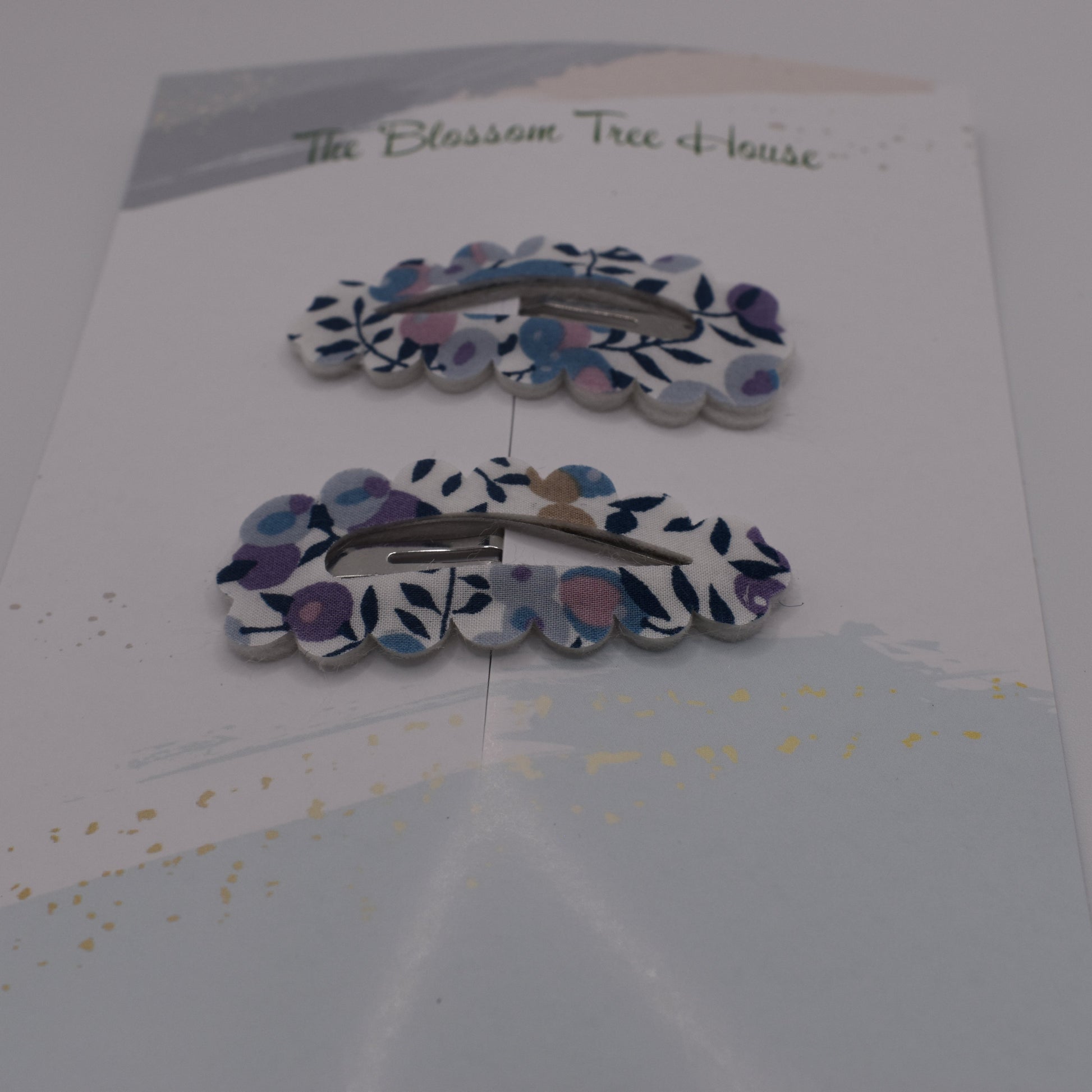 A barrette hair clip with a Liberty print design in Wiltshire Blue. Front-on view. Made by The Blossom Tree House