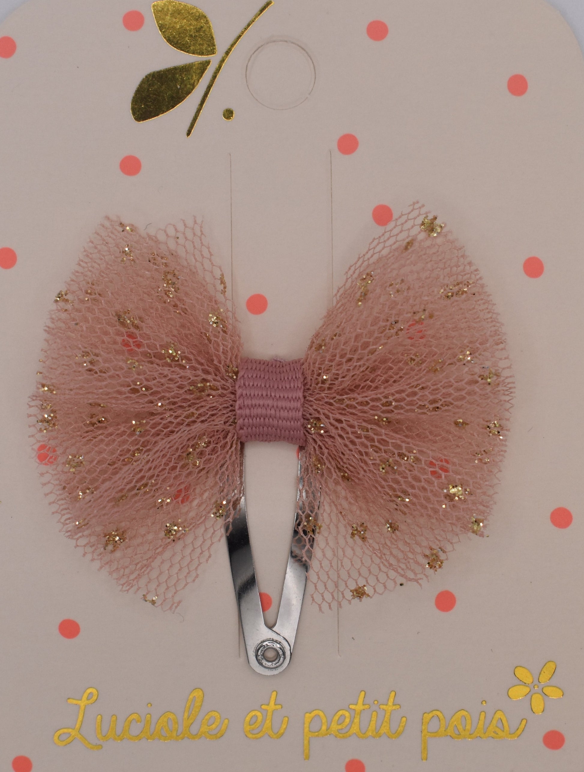 A mini tutu bow hair clip for girls. Pink fabric with gold sparkles. Top view. Made by Luciole et Petit Pois