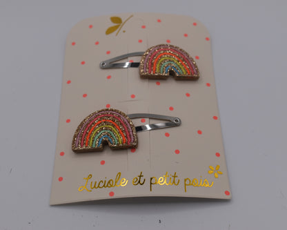 A pair of multicoloured rainbow hair clips for girls. Glittery. Front view. Made by Luciole et Petit Pois
