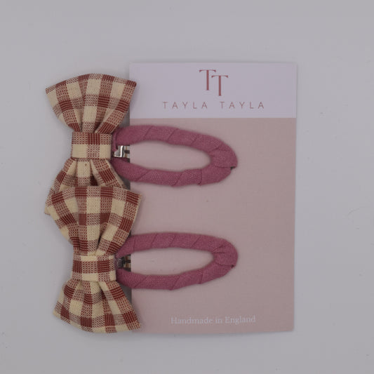 A set of pink gingham bow hair clips for girls. Fabric material. Top view. Made by Tayla Tayla