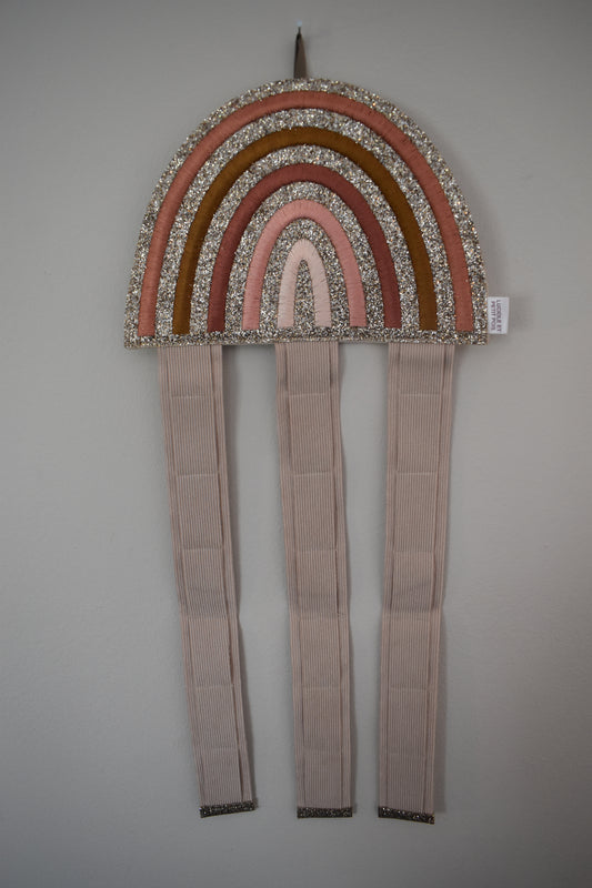A rainbow hair clip holder. Glittery and wall hanging. Perfect for storage of girls hair clips. Front view